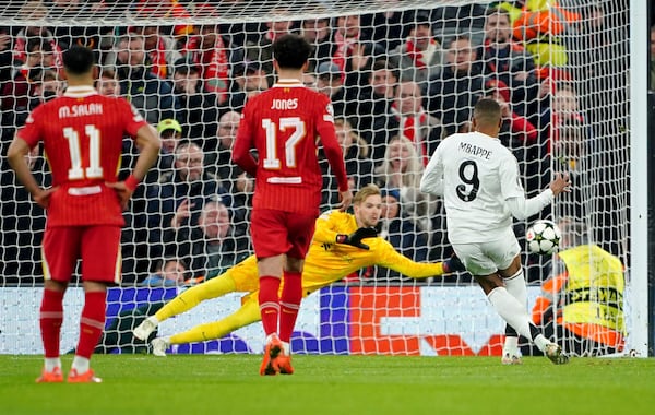 Liverpool goalkeeper Caoimhin Kelleher saves a penalty from Real Madrid's Kylian Mbappe during the Champions League opening phase soccer match between Liverpool and Real Madrid at Anfield Stadium, Liverpool, England, Wednesday, Nov. 27, 2024. (Peter Byrne/PA via AP)