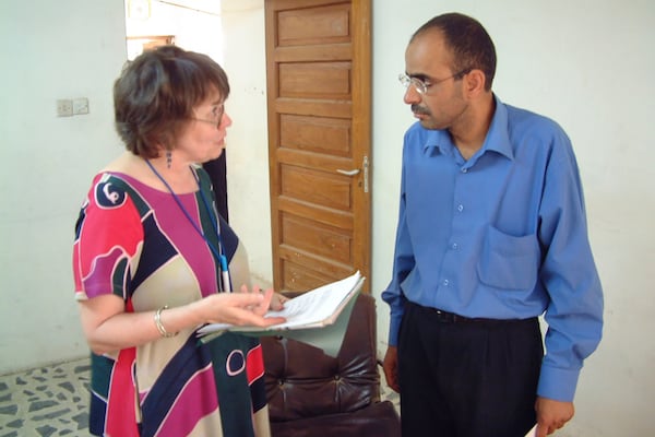 Earleen Fisher goes over a contract with a subscriber in Baghdad, Iraq, May 26, 2003. (AP Photo/Ted Anthony)