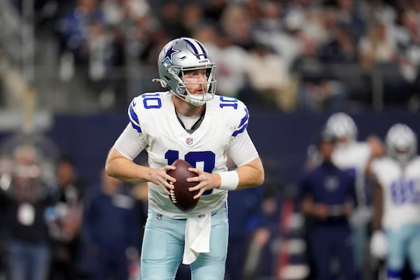 Dallas Cowboys quarterback Cooper Rush looks to throw a pass in the first half of an NFL football game against the Tampa Bay Buccaneers in Arlington, Texas, Sunday, Dec. 22, 2024. (AP Photo/Julio Cortez)