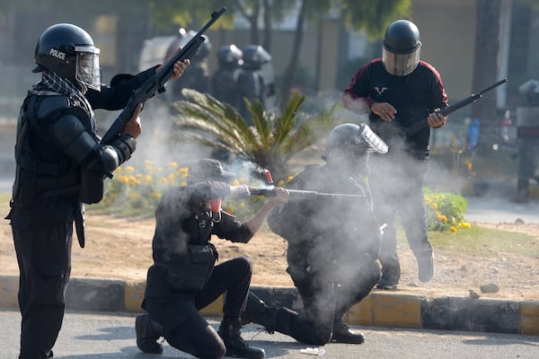 Police officers fire rubber bullets to disperse supporters of imprisoned former premier Imran Khan's Pakistan Tehreek-e-Insaf party, during clashes, in Islamabad, Pakistan, Tuesday, Nov. 26, 2024. (AP Photo/Irtisham Ahmed)