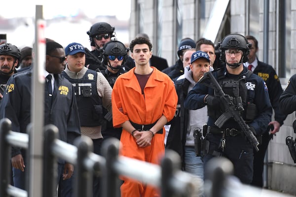 Luigi Mangione, a suspect in the fatal shooting of UnitedHealthcare CEO Brian Thompson, is escorted by police, Thursday, Dec. 19, 2024, in New York. (AP Photo/Pamela Smith)