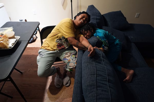 TiAnna Yeldell, left, spends time with her son Ivan, 8, right, at her home, Thursday, Nov. 14, 2024, in Missouri City, Texas. (AP Photo/Eric Gay)