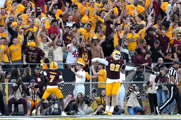 Arizona State defensive back Shamari Simmons (7) and defensive lineman Zac Swanson (92) celebrate an interception against BYU during the second half of an NCAA college football game Saturday, Nov. 23, 2024, in Tempe, Ariz. Arizona State won 28-23. (AP Photo/Ross D. Franklin)