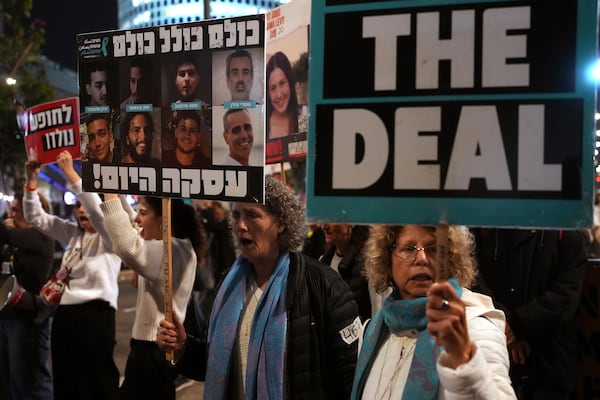 Relatives and friends of people killed and abducted by Hamas and taken into Gaza, take part in a demonstration in Tel Aviv, Israel, Wednesday, Jan. 15, 2025. (AP Photo/Ohad Zwigenberg)