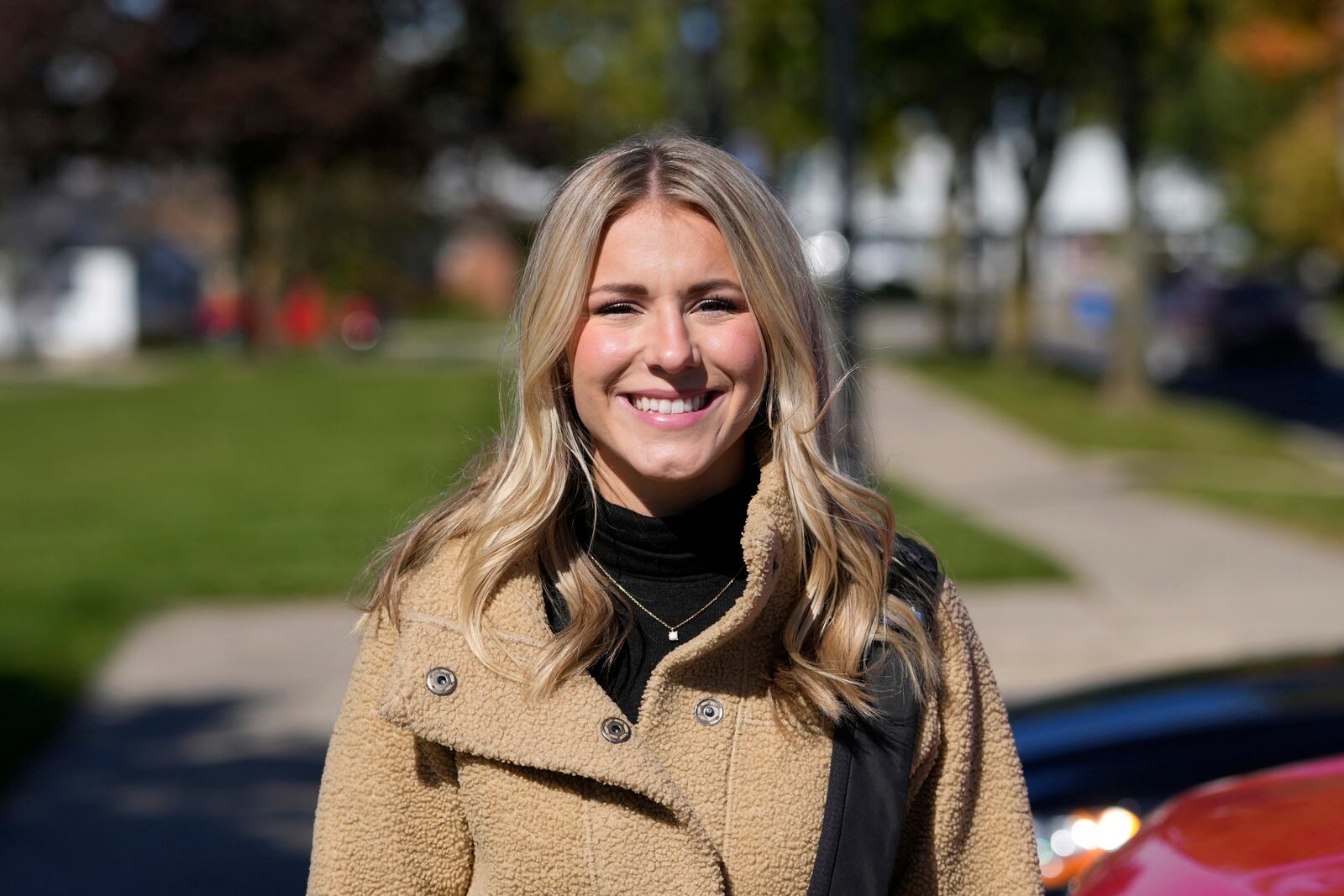 Republican Rylee Linting goes door to door campaigning hoping to unseat Democratic State Rep. Jaime Churches, Wednesday, Oct. 16, 2024, in Gibraltar, Mich. (AP Photo/Carlos Osorio)