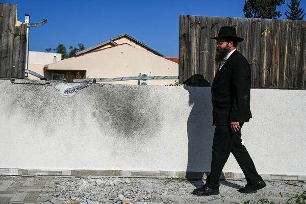 A man surveys a damaged home after a rocket fired by Palestinian militants from Gaza Strip hit in the town of Sderot, southern Israel Monday, Jan. 6, 2025. (AP Photo/Tsafrir Abayov)