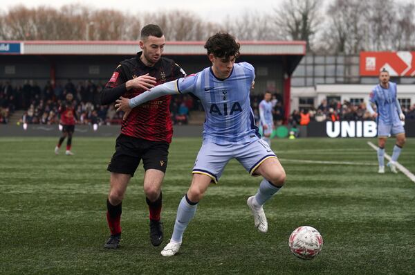 Tamworth's Thomas McLinchey, left, and Tottenham Hotspur's Archie Gray battle for the ball during the English FA Cup third round match at The Lamb Ground, Tamworth, England, Sunday Jan. 12, 2025. (Joe Giddens/PA via AP)