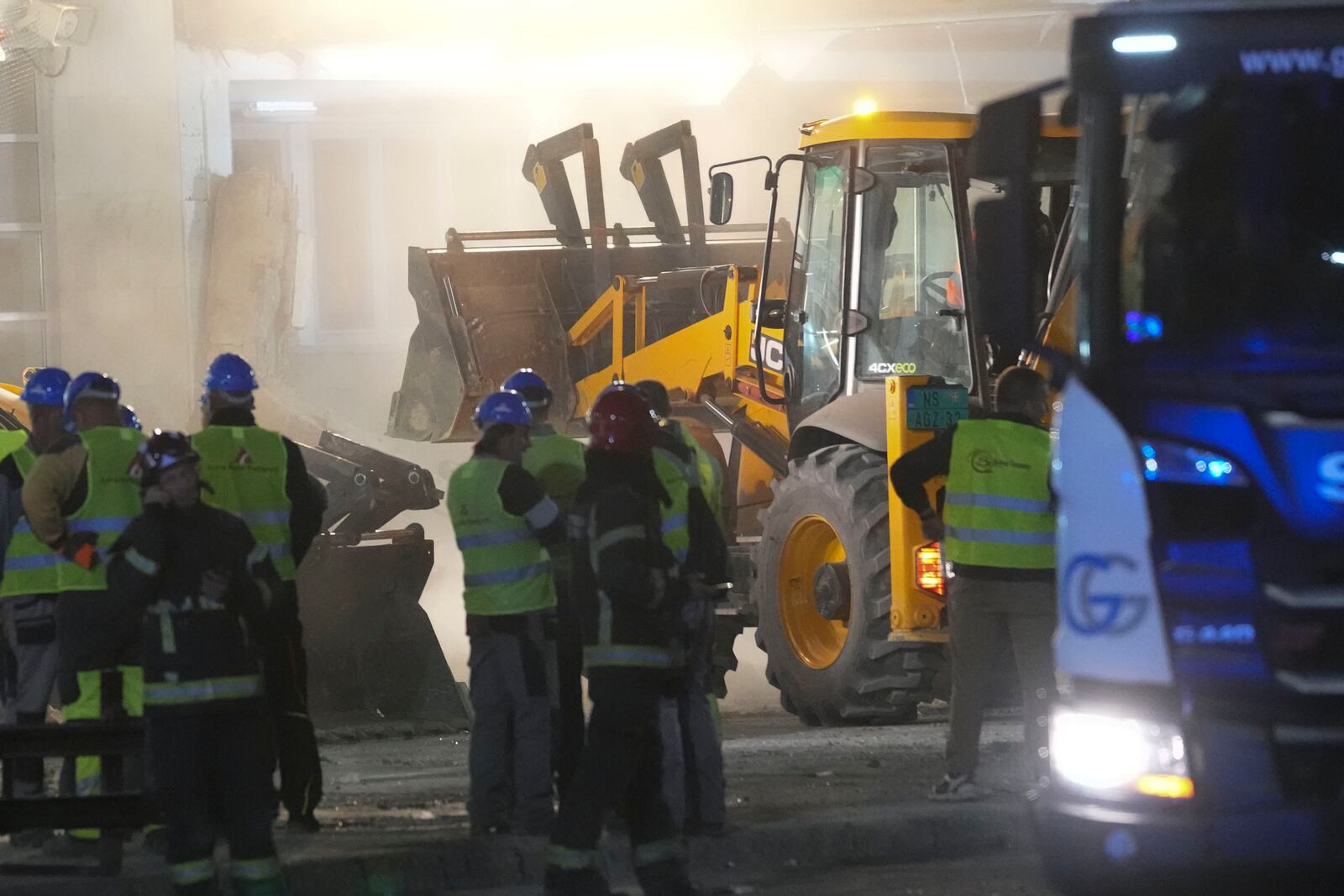 Rescue workers search for victims after an outdoor roof collapsed at a train station in Novi Sad, Serbia, Friday, Nov. 1, 2024. (AP Photo/Darko Vojinovic)