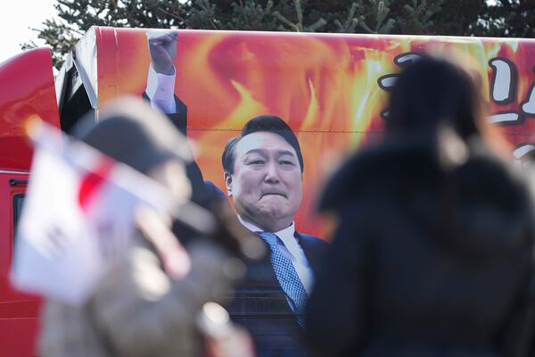 A picture of impeached South Korean President Yoon Suk Yeol is seen on the vehicle during a rally to oppose his impeachment outside of a detention center in Uiwang, South Korea, Friday, Jan. 17, 2025. (AP Photo/Lee Jin-man)