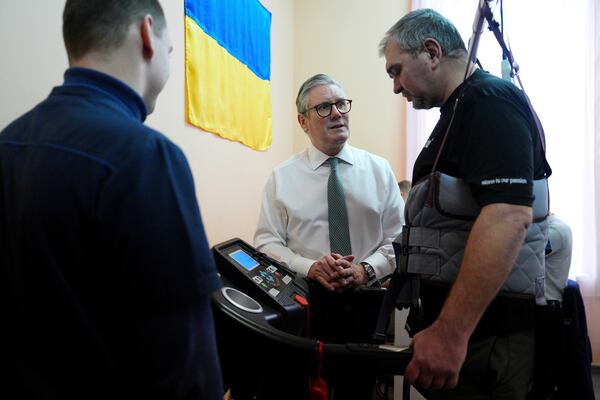 British Prime Minister Keir Starmer visits a hospital as a staff members tend to an injured patient, a Ukrainian service member, in Kyiv, Ukraine Thursday, Jan. 16, 2025. (Carl Court/Pool Photo via AP)