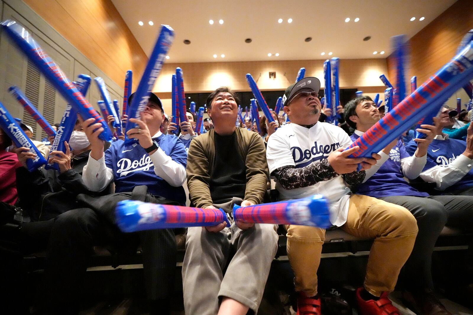 Fans cheer as they watch a live stream of the Game 3 of the baseball World Series between the Los Angeles Dodgers and the New York Yankees during a public viewing event in Oshu, northeastern Japan, the hometown of Shohei Ohtani of the Dodgers, Tuesday, Oct. 29, 2024. (AP Photo/Eugene Hoshiko)