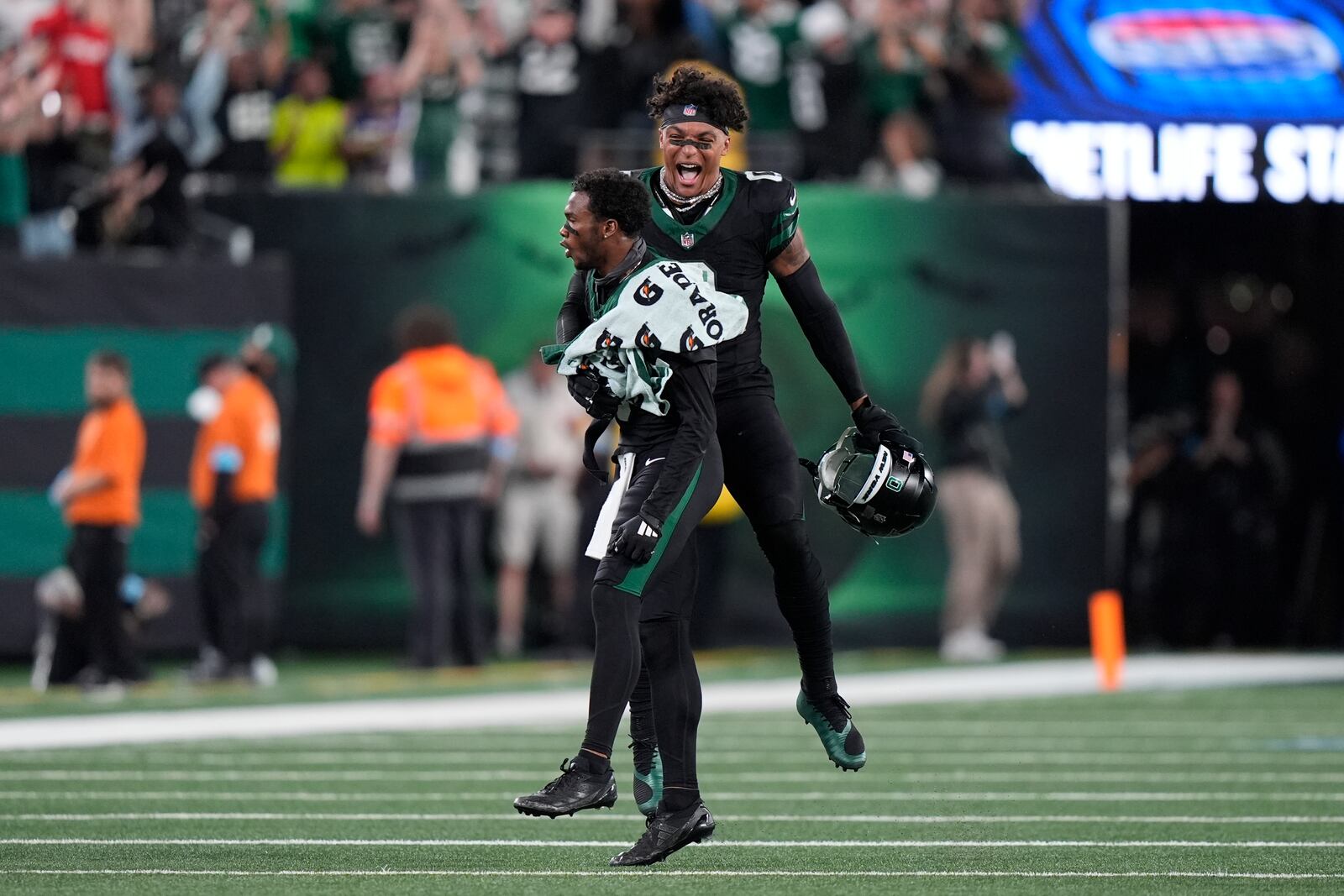 New York Jets wide receiver Garrett Wilson, left, and running back Braelon Allen (0) celebrate after Wilson's catch was ruled a touchdown during the second half of an NFL football game against the Houston Texans, Thursday, Oct. 31, 2024, in East Rutherford, N.J. (AP Photo/Frank Franklin II)