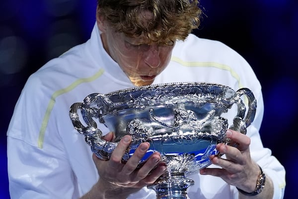 Jannik Sinner of Italy looks into the Norman Brookes Challenge Cup after defeating Alexander Zverev of Germany in the men's singles final at the Australian Open tennis championship in Melbourne, Australia, Sunday, Jan. 26, 2025. (AP Photo/Ng Han Guan)