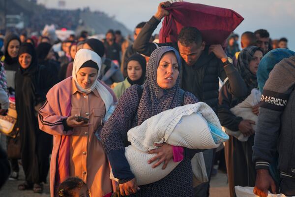 Displaced Palestinians return to their homes in the northern Gaza Strip, following Israel's decision to allow thousands of them to go back for the first time since the early weeks of the 15-month war with Hamas, Monday, Jan. 27, 2025. (AP Photo/Abdel Kareem Hana)