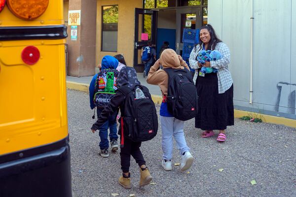 Social worker Mary Schmauss, right, greets students as they arrive for school, Tuesday, Oct. 1, 2024, at Algodones Elementary School in Algodones, N.M. (AP Photo/Roberto E. Rosales)