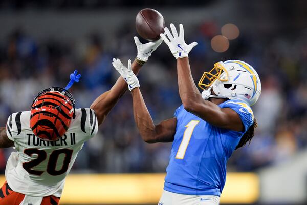 Cincinnati Bengals cornerback DJ Turner II (20) breaks up a pass intended for Los Angeles Chargers wide receiver Quentin Johnston (1) during the second half of an NFL football game Sunday, Nov. 17, 2024, in Inglewood, Calif. (AP Photo/Gregory Bull)