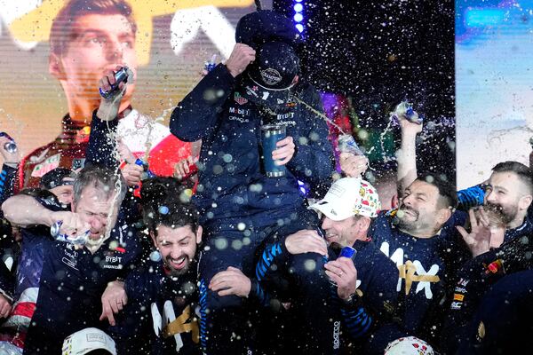 Red Bull driver Max Verstappen, of the Netherlands, center, celebrates winning the Formula 1 championship with his team after the F1 Las Vegas Grand Prix auto race, Sunday, Nov. 24, 2024, in Las Vegas. (AP Photo/John Locher)