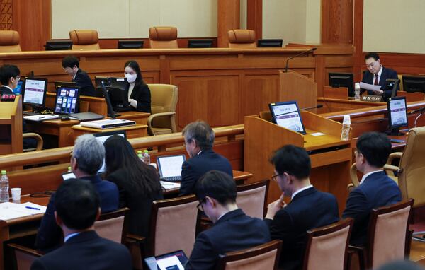 South Korea's impeached President Yoon Suk Yeol, right, attends the fourth hearing of his impeachment trial over his short-lived imposition of martial law at the Constitutional Court in Seoul, South Korea, Jan.23, 2025. (Jeon Heon Kyun/Pool Photo via AP)