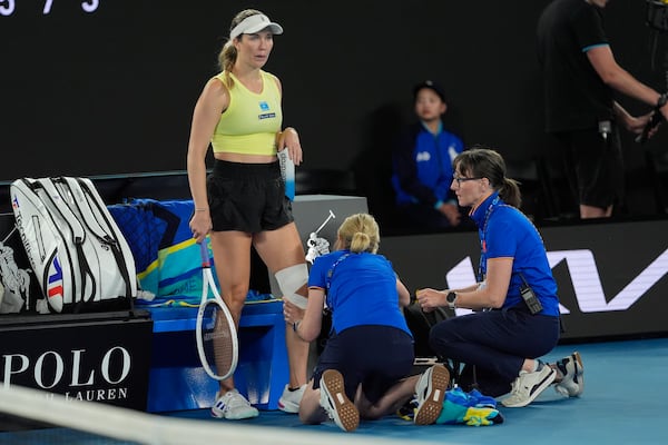 Danielle Collins of the U.S. gets her knee attended to during a third round match against Madison Keys of the U.S. at the Australian Open tennis championship in Melbourne, Australia, Saturday, Jan. 18, 2025. (AP Photo/Asanka Brendon Ratnayake)