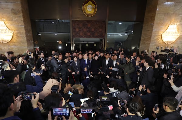 South Korea's main opposition Democratic Party leader Lee Jae-myung, top center, speaks at the National Assembly in Seoul, South Korea, Wednesday, Dec. 4, 2024. (Kim Ju-hyung/Yonhap via AP)