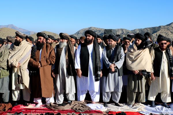 Foreign Minister Amir Khan Muttaqi, center, and mourners offer funeral prayers of Khalil Haqqani, the minister for refugees and repatriation, during his funeral procession in eastern Paktia province, Afghanistan, Thursday, Dec. 12, 2024. (AP Photo/Saifullah Zahir)