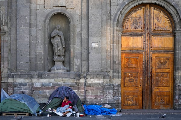 A Venezuelan migrant wakes up at a migrant tent camp outside La Soledad church in Mexico City, Monday, Jan. 20, 2025, the inauguration day of U.S. President Donald Trump. (AP Photo/Fernando Llano)