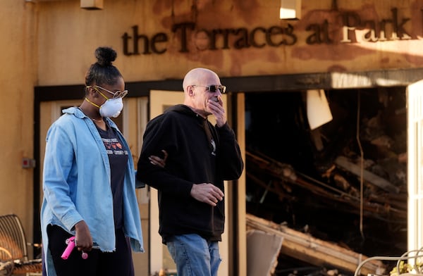 Sam Baum, right, community relations director at the Terraces at Park Marino assisted living facility, is consoled by Activities Director Lashawna Thompson after seeing fire damage to the facility from the Eaton Fire on Monday, Jan. 13, 2025, in Pasadena, Calif. (AP Photo/Chris Pizzello)