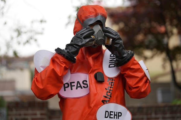 An environment activist wearing a suit prepares for a rally calling for a strong global plastics treaty ahead of the fifth session of the Intergovernmental Negotiating Committee on Plastic Pollution which set to be held in Busan from Nov. 25 to Dec. 1, in Seoul, South Korea, Wednesday, Nov. 20, 2024. (AP Photo/Lee Jin-man)