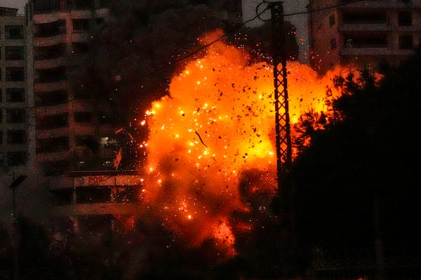 Flames and debris erupt from an Israeli airstrike that targeted a building in Tayouneh, Beirut, Lebanon, Monday, Nov. 25, 2024. (AP Photo/Hassan Ammar)