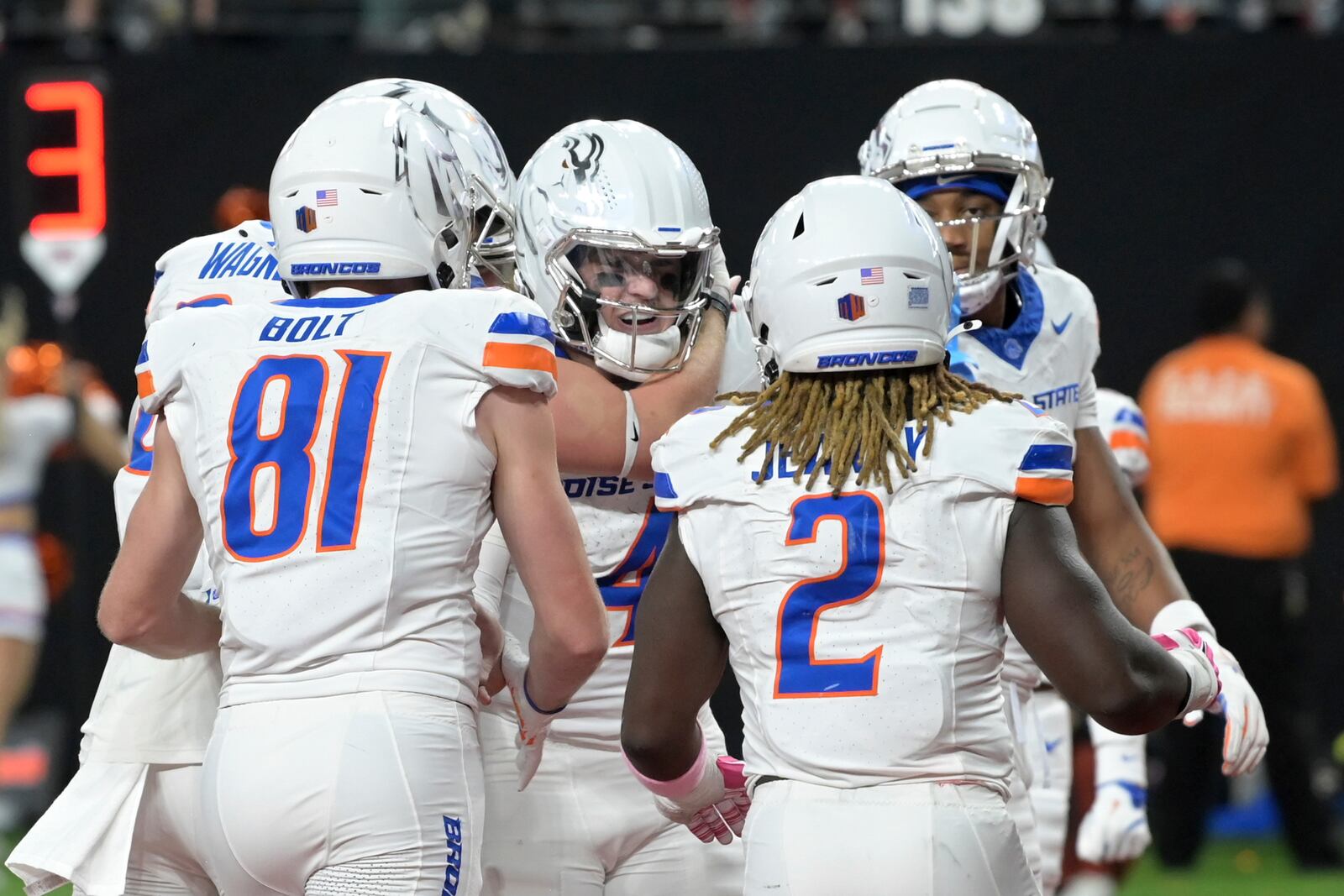 Boise State quarterback Maddux Madsen (4) is mobbed by teammates after scoring a touchdown against UNLV during the first half of an NCAA college football game Friday, Oct. 25, 2024, in Las Vegas. (AP Photo/Sam Morris)