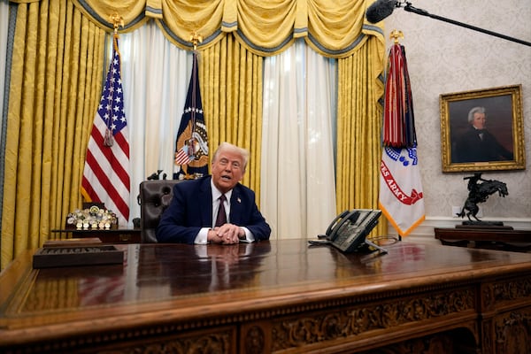 FILE - President Donald Trump answers questions from reporters as he signs an executive orders in the Oval Office of the White House, Jan. 23, 2025, in Washington. (AP Photo/Ben Curtis, File)