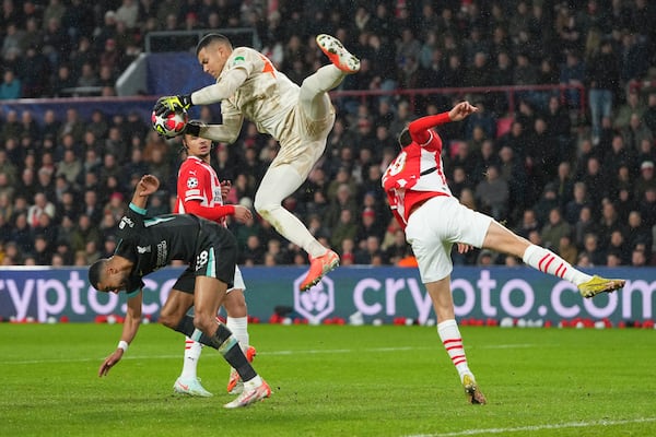 PSV's goalkeeper Walter Benitez saves over Liverpool's Cody Gakpo during the Champions League opening phase soccer match between PSV and Liverpool at Phillips Stadium in Eindhoven, Netherlands, Wednesday, Jan. 29, 2025. (AP Photo/Peter Dejong)