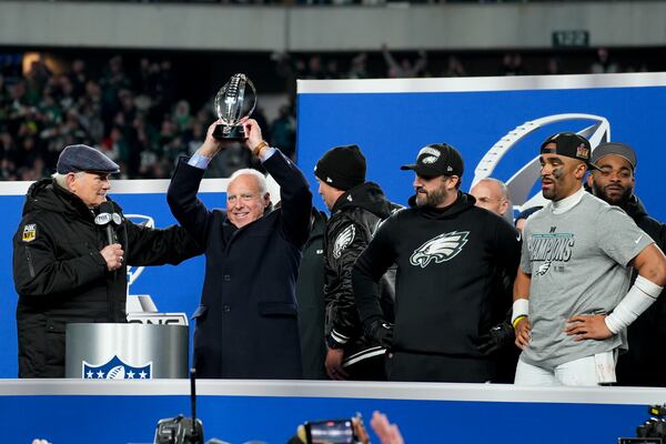 Philadelphia Eagles owner Jeffrey Lurie celebrates with the trophy after their win against the Washington Commanders in the NFC Championship NFL football game, Sunday, Jan. 26, 2025, in Philadelphia. (AP Photo/Chris Szagola)