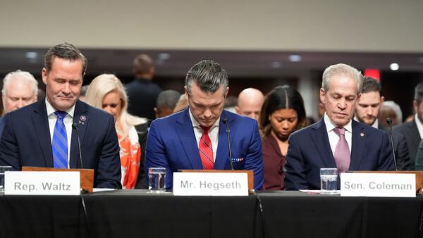 Pete Hegseth, center, President-elect Donald Trump's choice to be Defense secretary, appears before the Senate Armed Services Committee for his confirmation hearing with Rep. Michael Waltz, R-Fla., left, and former Sen. Norm Coleman during a moment of silence for the city of Los Angeles, at the Capitol in Washington, Tuesday, Jan. 14, 2025. (AP Photo/Alex Brandon)