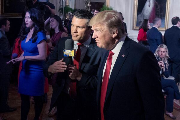 FILE - President Donald Trump, right, appears on Fox & Friends with co-host Pete Hegseth at a Wounded Warrior Project Soldier Ride event in the East Room of the White House in Washington, April 6, 2017. (AP Photo/Andrew Harnik, File)