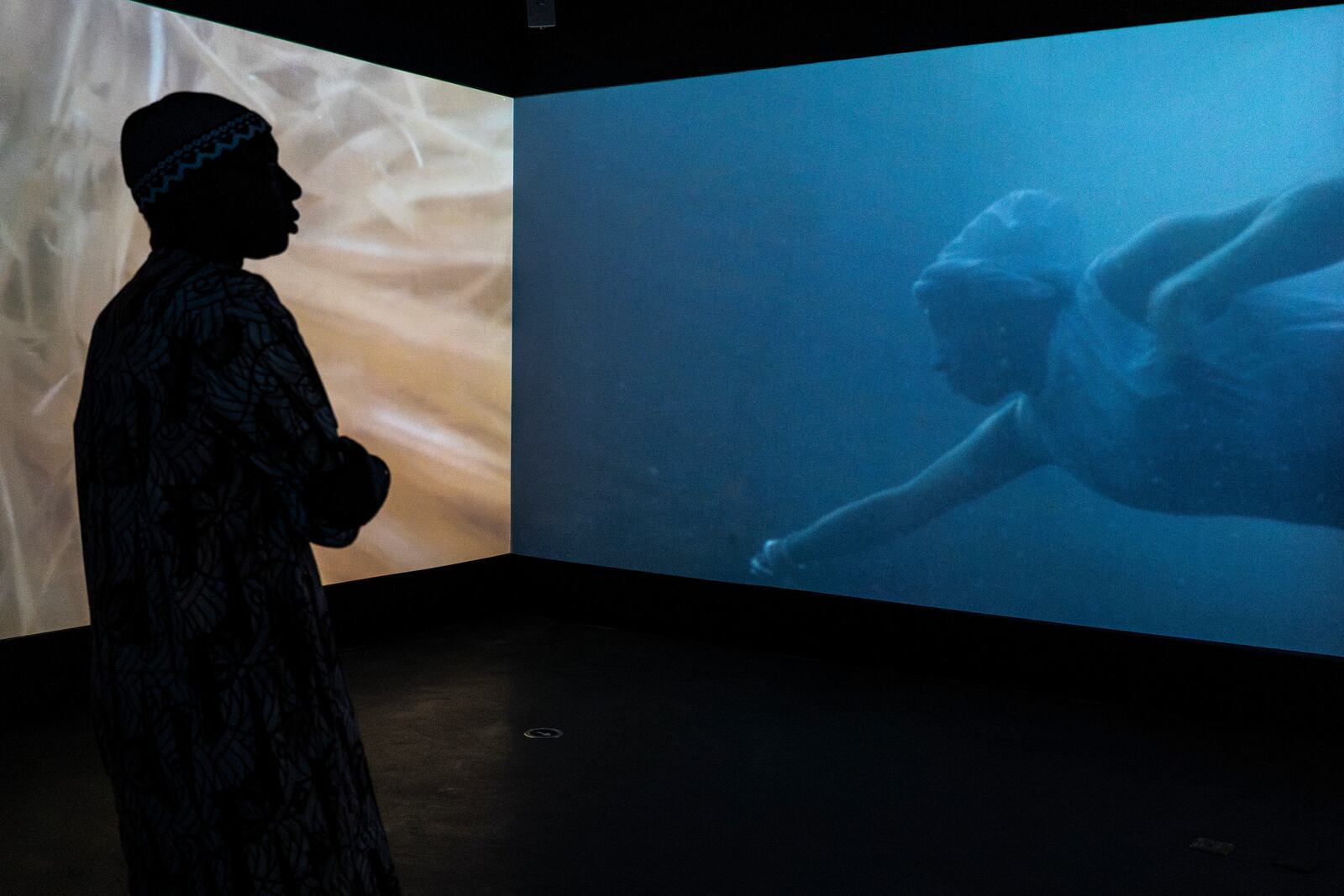 A visitor explores the international exhibit at the Dakar Biennale of Contemporary African Art in Dakar, Senegal, Friday, Nov. 8, 2024. (AP Photo/Annika Hammerschlag)