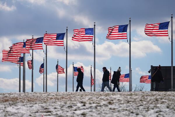 U.S. flags around the Washington Monument are at full staff during the 60th Presidential Inauguration, Monday, Jan. 20, 2025, in Washington. Flags are supposed to fly at half-staff through the end of January out of respect for former President Jimmy Carter, who died Dec. 29, 2024. (AP Photo/Julio Cortez)