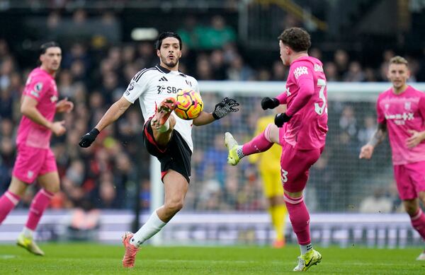 Fulham's Raul Jimenez, left, and Ipswich Town's Nathan fight for the ball during the English Premier League soccer match between Fulham and Ipswich Town at Craven Cottage stadium, London, Sunday Jan. 5, 2025. (Andrew Matthews/PA via AP)