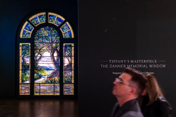 People walk near The Danner Memorial Window, by Tiffany Studios during an auction preview at Sotheby's in New York, Monday, Nov. 11, 2024. (AP Photo/Eduardo Munoz Alvarez)