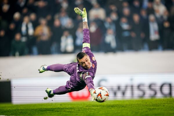 Galatasaray goalkeeper Fernando Muslera dives to reach the ball during the Europa League opening phase soccer match between Malmo FF and Galatasaray SK at the Malmo New Stadium in Malmo, Sweden, Thursday, Dec. 12, 2024. (Andreas Hillergren/TT News Agency via AP)