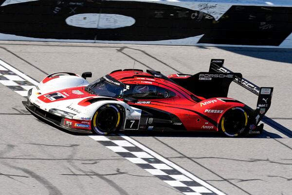 Felipe Nasr, of Brazil, crosses the finish line in his Porsche 963 to win the IMSA Rolex 24 hour auto race at Daytona International Speedway, Sunday, Jan. 26, 2025, in Daytona Beach, Fla. (AP Photo/John Raoux)