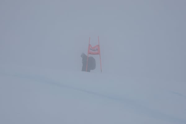 A gate is barely seen through the fog as an alpine ski, women's World Cup Super G race was canceled due to strong winds and poor visibility, in St. Moritz, Switzerland, Sunday, Dec. 22, 2024. (AP Photo/Marco Trovati)