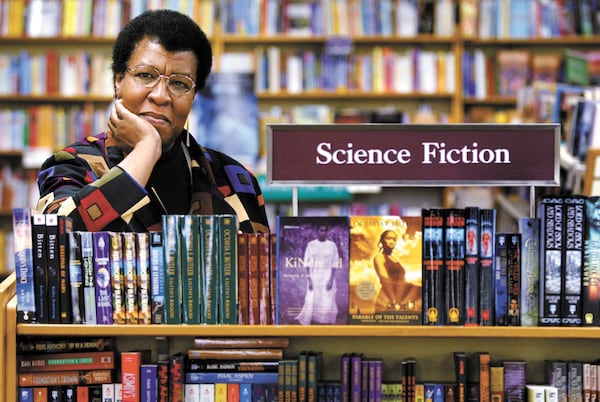 FILE - Science Fiction writer Octavia Butler poses for a photograph near some of her novels at University Book Store in Seattle, Wash., on Feb. 4, 2004. (Joshua Trujillo/seattlepi.com via AP, File)