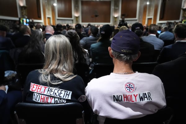 Protesters attend the Pete Hegseth, President-elect Donald Trump's choice to be Defense secretary, Senate Armed Services Committee confirmation hearing, at the Capitol in Washington, Tuesday, Jan. 14, 2025. (AP Photo/Jacquelyn Martin)