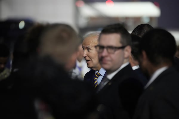 President Joe Biden greets well wishers after arriving at Quatro de Fevereiro international airport in the capital Luanda, Angola on Monday, Dec. 2, 2024, on his long-promised visit to Africa. (AP Photo/Ben Curtis)