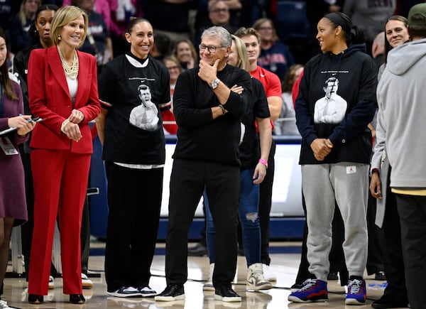 UConn head coach Geno Auriemma, center, stands with associate head coach Chris Dailey, left, and former players Diana Taurasi, second from left, and Maya Moore Irons, right, after defeating Fairleigh Dickinson to surpass Tara VanDerveer for the most wins in college basketball history, Wednesday, Nov. 20, 2024, in Storrs, Conn. (AP Photo/Jessica Hill)