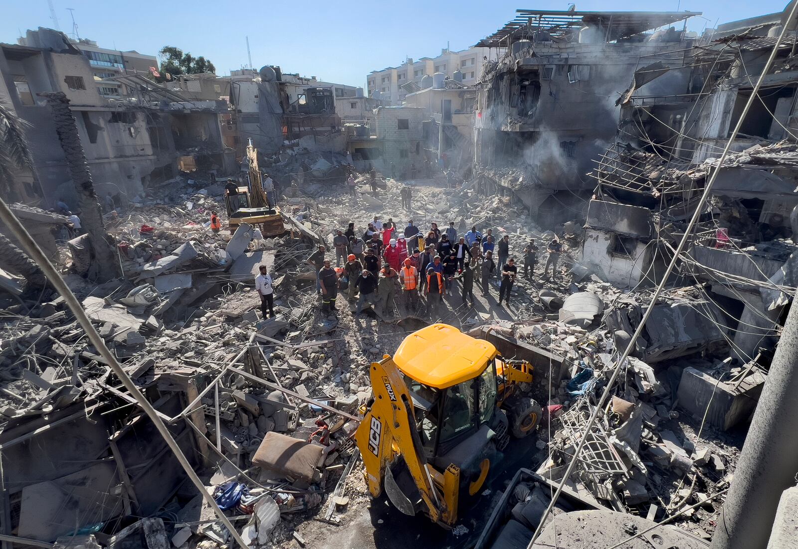 Rescue workers search for victims at a popular neighbourhood that was hit Monday night by Israeli airstrikes, south of Beirut, Lebanon, Tuesday, Oct. 22, 2024. (AP Photo/Hussein Malla)