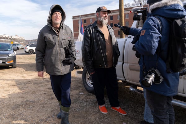 Supporters of President Donald Trump, Kevin Loftus, left and William Sarsfield III, center, who were convicted for participating in the Jan. 6 riot at the U.S. Capitol, talk to reporters after being pardoned and released in the early morning hours from the Philadelphia Federal Detention Center before traveling to Washington, Tuesday, Jan. 21, 2025. (AP Photo/Jose Luis Magana)