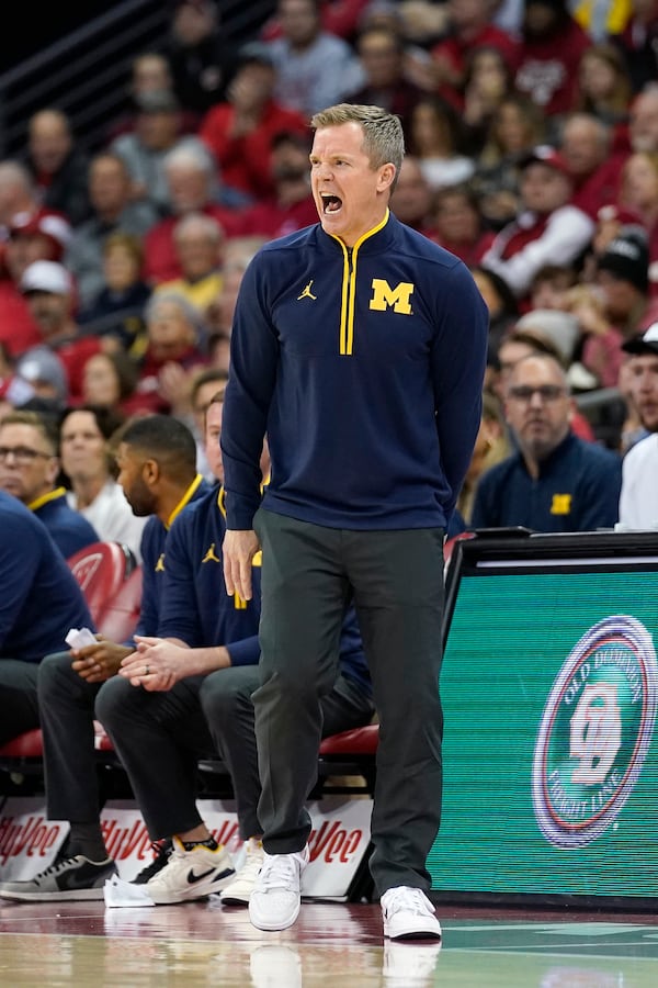 Michigan head coach Dusty May yells to his players during the first half of an NCAA college basketball game against Wisconsin, Tuesday, Dec. 3, 2024, in Madison, Wis. (AP Photo/Kayla Wolf)