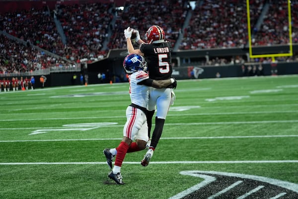 New York Giants cornerback Deonte Banks (3) breaks up a pass intended for Atlanta Falcons wide receiver Drake London (5) in the second half of an NFL football game in Atlanta, Sunday, Dec. 22, 2024. (AP Photo/John Bazemore)